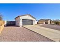 This single-Gathering home has an attached garage, desert landscaping and a paved driveway at 12722 W Diaz Dr, Arizona City, AZ 85123