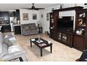 Comfortable living room features tiled flooring, a ceiling fan, and a cozy seating area at 13219 W Aleppo Dr, Sun City West, AZ 85375