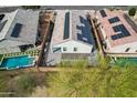 Birds-eye view of a property featuring solar panels, a private backyard, and turquoise pool at 13529 W Remuda Dr, Peoria, AZ 85383