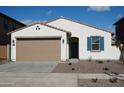 Charming single-story home with a two-car garage, low-maintenance landscaping, and stylish exterior accents at 14132 W Valentine St, Surprise, AZ 85379