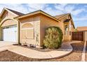 Exterior of a home showcasing the concrete walkway, brown rock, and landscaping at 1538 E Peach Tree Dr, Chandler, AZ 85249