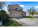 Two-story home features a neutral exterior, tile roof, attached two-car garage, and a well-maintained lawn at 15646 N 20Th Ave, Phoenix, AZ 85023