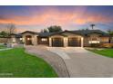 Expansive property with a long driveway leading to a spacious three-car garage at 1801 E Berridge Ln, Phoenix, AZ 85016