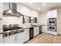 Modern kitchen with stainless steel appliances, white cabinets, and sleek countertops at 1801 E Berridge Ln, Phoenix, AZ 85016