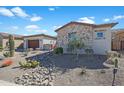 This is a view of the side of the home with desert landscaping and a rock drainage ditch at 18601 W Thunderhill Pl, Goodyear, AZ 85338