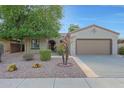 Single-story home featuring a low maintenance desert landscape and a two car garage at 19602 N Canyon Whisper Dr, Surprise, AZ 85387