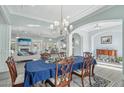 Open-concept floor plan featuring a dining area with a chandelier and access to the living room and kitchen at 2102 E Norwood St, Mesa, AZ 85213