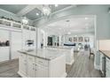 Open-concept kitchen with marble countertops, custom cabinets, and seamless flow to the living area at 2102 E Norwood St, Mesa, AZ 85213