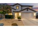 Charming two-story home showcasing a well-manicured front yard, desert landscaping, and an attached two-car garage at 2708 E Desert Rose Trl, San Tan Valley, AZ 85143