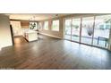 Spacious living room featuring lots of natural light and hardwood flooring at 2734 N Trevino Pl, Mesa, AZ 85215