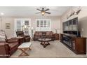 Cozy living room with neutral walls, plush carpeting, and comfortable brown leather furniture at 3061 S Elderwood --, Mesa, AZ 85212