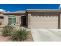 Front exterior view of the house showing the front door and two-car garage at 3117 S Signal Butte Rd # 501, Mesa, AZ 85212