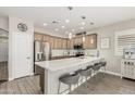 Open kitchen featuring stainless steel appliances, a spacious island, and modern pendant lighting at 3117 S Signal Butte Rd # 501, Mesa, AZ 85212