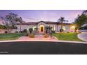 Charming single-story home with manicured lawn, lush landscaping, and inviting curb appeal at 3527 E Indigo Cir, Mesa, AZ 85213