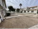 A condo exterior showcases a well-kept landscape and a walkway around the building at 3840 N 43Rd Ave # 73, Phoenix, AZ 85031