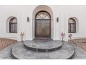 Stylish front entrance with a classic arched doorway, complemented by modern lighting and desert decor at 5345 E Mclellan Rd # 107, Mesa, AZ 85205