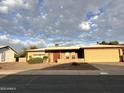 Charming single-story home with a brick facade, low-maintenance landscaping, and a two-car garage at 635 N 67Th Pl, Mesa, AZ 85205