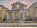 Charming two-story home with a cozy front porch, desert landscaping and neutral color scheme at 7769 W Bonitos Dr, Phoenix, AZ 85035