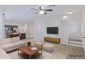 Staged living room showcases the open floor plan and natural light, with a tv and modern furniture at 7769 W Bonitos Dr, Phoenix, AZ 85035