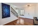 Bright foyer features hardwood floors, staircase, and a striking blue painting upon entry at 11011 N 92Nd St # 1019, Scottsdale, AZ 85260