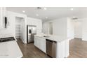 Modern kitchen featuring white cabinets, stainless steel appliances, and an island with a sink at 12373 W Marguerite Ave, Avondale, AZ 85323