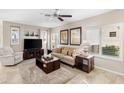 Bright living room features tile flooring, cozy seating, and stylish decor with lots of natural light at 1475 N Agave St, Casa Grande, AZ 85122