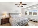 Serene bedroom with tile floors, neutral tones, a ceiling fan, and bright windows, creating a calm retreat at 1475 N Agave St, Casa Grande, AZ 85122