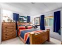 Bedroom with a bed, nightstand, dresser, and window with curtains at 1779 S 74Th St, Mesa, AZ 85209