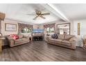 Spacious living room boasting wood-look floors, comfortable sofas, and a large television at 1779 S 74Th St, Mesa, AZ 85209