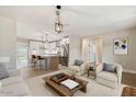 Open concept living room leading into a kitchen and dining area, creating an inviting space at 2202 E Osborn Rd, Phoenix, AZ 85016