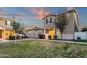 Charming two-story home with neutral siding, manicured lawn, and inviting front yard with mature landscaping at 3802 E Stiles Ln, Gilbert, AZ 85295