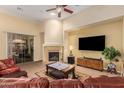 Cozy living room featuring a fireplace, sliding glass doors, and modern television at 4192 E Carriage Way, Gilbert, AZ 85297