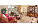 Comfortable living room with abundant natural light, display cabinet and stylish décor at 4192 E Carriage Way, Gilbert, AZ 85297