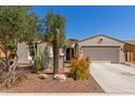 Charming single-Gathering home with a desert landscaped front yard, gated entry, and an attached two-car garage at 4481 N Luna W Rd, Litchfield Park, AZ 85340