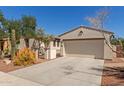 Single-Gathering home featuring desert landscaping, a gated entry, a two-car garage, and a well-maintained front yard at 4481 N Luna W Rd, Litchfield Park, AZ 85340