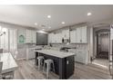 Modern kitchen with a center island, white cabinets, and stainless steel appliances at 502 E Kona Dr, Casa Grande, AZ 85122