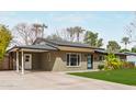 Charming single-story home featuring a well-maintained lawn, desert landscaping, and a convenient carport at 520 W Townley Ave, Phoenix, AZ 85021