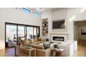 Bright and airy living room boasts a fireplace, vaulted ceilings, built-in shelving, and access to a covered patio at 6621 E Doubletree Ranch Rd, Paradise Valley, AZ 85253