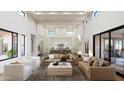 Spacious living area showcasing high ceilings, clerestory windows, and access to the kitchen and outdoor spaces at 6621 E Doubletree Ranch Rd, Paradise Valley, AZ 85253