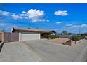 Charming single-story home featuring a well-manicured front yard and a two-car garage at 7102 W Wilshire Dr, Phoenix, AZ 85035