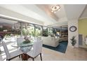 Bright living room featuring a glass dining table with seating and views of the lush exterior at 7121 E Rancho Vista Dr # 1008, Scottsdale, AZ 85251