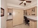 This office features a built-in desk, cabinetry, shelving, and a convenient murphy bed at 7121 E Rancho Vista Dr # 1008, Scottsdale, AZ 85251
