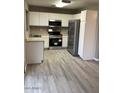 The kitchen features white cabinets and stainless steel appliances at 8929 E Bramble Ave, Mesa, AZ 85208
