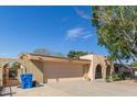 Attached garage with brick accents and covered front entry at 9022 N 39Th Ave, Phoenix, AZ 85051