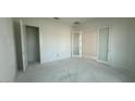 Unfinished bedroom with three doorways, neutral paint and lighting fixtures at 11447 E Utah Ave, Mesa, AZ 85212