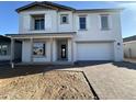 Charming two-story home showcasing a neutral color palette, white shutters, and a brick-paved driveway at 11447 E Utah Ave, Mesa, AZ 85212