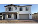 Charming two-story home featuring a neutral color palette, a two-car garage, and a welcoming front porch at 11447 E Utah Ave, Mesa, AZ 85212