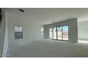 Unfinished living room with sliding glass doors, neutral paint, and windows at 11447 E Utah Ave, Mesa, AZ 85212