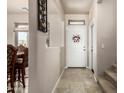 Inviting entryway features neutral walls and tile floor with a white door adorned by a floral wreath at 13212 W Lisbon Ln, Surprise, AZ 85379