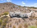 Desert home with a flat roof with mountain views and landscaping offering a private escape at 1550 W Adobe Dam Dr, San Tan Valley, AZ 85144